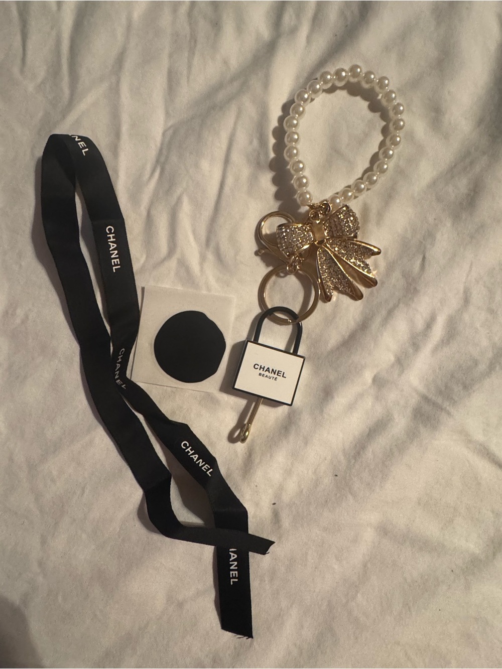 CHANEL Pearl Bracelet Keyring with Gold Bow & Padlock Charm